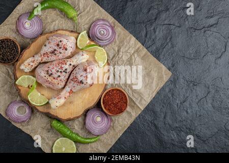 Fresh raw chicken drumsticks and vegetables , spices and vegetables Stock Photo