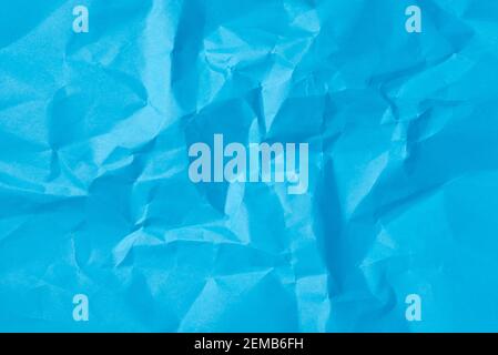 Crumpled sheet of blue paper as a textural background for design ideas Stock Photo