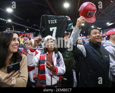 Former Atlanta Falcons and Philadelphia Eagles quarterback Michael Vick  wears one of his special edition New Era hats on sale in the NFL Shop at  the Super Bowl Experience on Thursday, Jan.