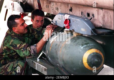 File photo dated 21/01/91 of Dave McLaughlin from Berwick-on-Tweed in Scotland making final adjustments to a 1000 pound bomb being fitted under a Tornado bomber in Bahrain, during the 1991 Gulf war. Issue date: Thursday February 25, 2021. Margaret Thatcher was urged by a government colleague not to embark on a smear campaign against Saddam Hussein at the start of the Gulf War amid concerns over Britain's arms dealings with the Iraqi regime, previously classified papers reveal. Foreign Office minister William Waldegrave said 'propaganda' against Saddam, requested by the then prime minister, was Stock Photo