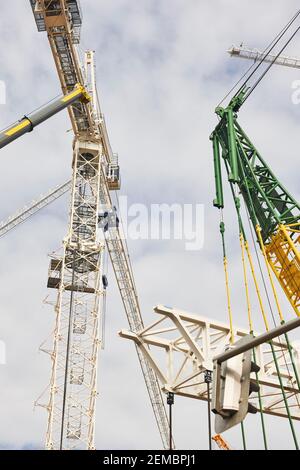 Telescopic cranes under a white sky. Construction engineering industry Stock Photo