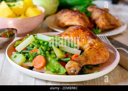 A plate with chicken vegetables and potatoes Stock Photo