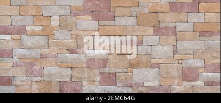 Bright pastel panoramic wall made of colored, square stones Stock Photo