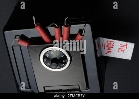 5 bangers in a toy safe called 'The Bank'. Set to 'blow open the safe'. Stock Photo