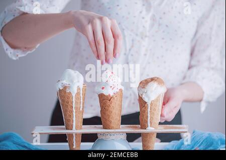 Three ice cream cones on a wooden background Stock Photo
