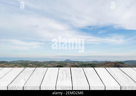 Empty white wood table top over nature blue sky landscape. Stock Photo