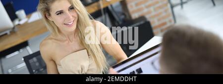 Businesswoman and businessman at work table discussing business figures on graphs Stock Photo