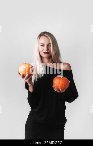 Beautiful witch with pumpkins Stock Photo