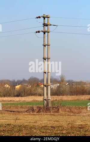 Concrete electrical power line utility pole with ceramic insulators and ...