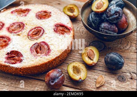 Pie with plum. In rustic style on a wooden surface Stock Photo