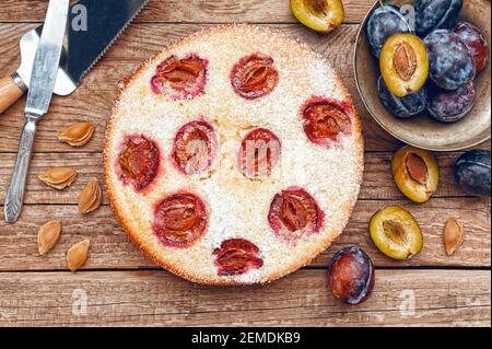 Pie with plum. In rustic style on a wooden surface Stock Photo