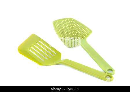 Green plastic kitchen utensils isolated on white background. Stock Photo