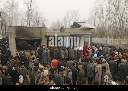 SRINAGAR, INDIA – FEBRUARY 12: People gather near a house that was damaged during a gunfight between militants and security forces at the Ratnipora area of south Kashmir's Pulwama district, some 30 kilometers south of Srinagar, on February 12, 2019 in Jammu and Kashmir, India. (Photo by Waseem Andrabi/ Hindustan Times/Sipa USA)