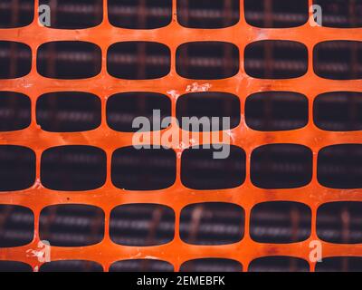 orange plastic net on construction site. Texture background of net. orange rectangle pattern Stock Photo