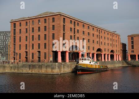 Liverpool, United Kingdom, 2nd February, 2020: Old brocklebank boat moored outside royal albert dock buildings on a sunny spring day, calm water. Stock Photo