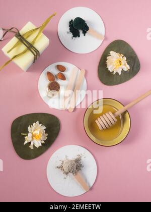 natural skin care products: brown sugar, lemon, clay powder, almond oil, honey, soap. Colorful background of natural cosmetics and flowers. natural in Stock Photo