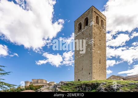 The Civic Tower of San Leo, Rimini, Italy, with the Fort of San Leo in the background Stock Photo