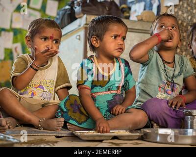 Rajasthan. India. 07-02-2018. Children are eating while attending school in a village in the Rajasthan. Stock Photo