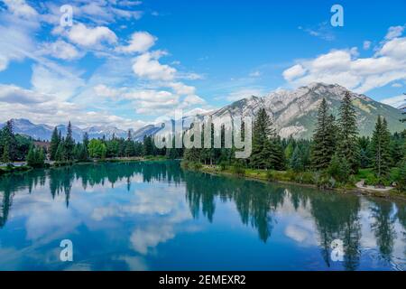 Town of Banff Central Park, Bow River Trail scenery in summer sunny day. Banff National Park, Canadian Rockies, Alberta, Canada. Mount Norquay in the Stock Photo
