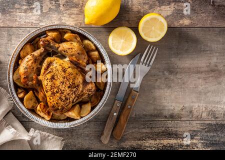 Homemade roasted chicken on wooden table Stock Photo