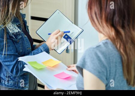 Two young coworkers enjoying working together, discussing their ideas Stock Photo