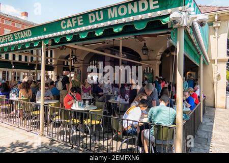 Crowded Cafe du Monde where they sell their famous beignets in the French Quarter of New Orleans, Louisiana, USA,