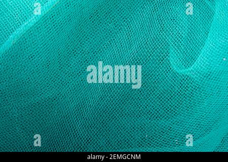 Green mesh. Green textile background. Stock Photo