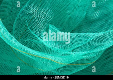 Green mesh. Green textile background. Stock Photo