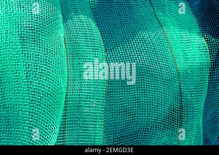 Green mesh. Green textile background. Stock Photo