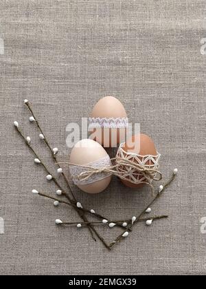 Easter composition decorated by lace Easter eggs on linen background Stock Photo