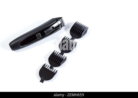 Black electric trimmer for shaving with attachments isolated on a white, with copy space. Stock Photo