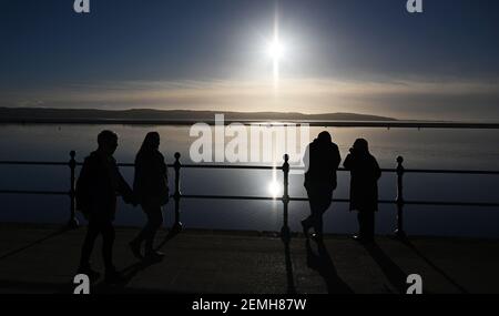 Pedestrians admire the view at West Kirby Marine Lake, Wirral, UK Stock Photo