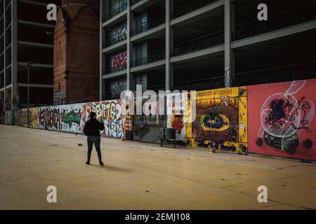 Barcelona, Spain. 25th Feb, 2021. A commuter takes a photo of vandalized graffitis painted in support of imprisoned rap artist Pablo Hasel. convicted to jail for glorifying terrorism and insulting Spain's former king in lyrics. Credit: Matthias Oesterle/Alamy Live News
