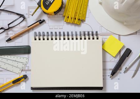 Architect engineer blank notebook, project blueprints background. Real estate design, construction site office concept, top view. Stock Photo