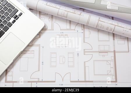 Architect engineer office desk. Residential building project architectural design blueprints and computer laptop, copy space. Stock Photo