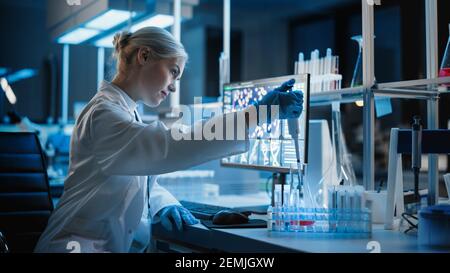 Medical Research Laboratory: Portrait of Female Scientist Working with Samples, using Micro Pipette Analysing Sample. Advanced Scientific Lab for Stock Photo