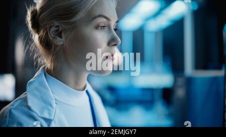Medical Research Laboratory: Close-up Side View Portrait of Female Scientist Working on Computer. Advanced Scientific Lab for Medicine, Biotechnology Stock Photo