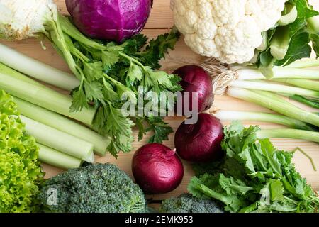 organic vegetables, purple onion, celery, leek, broccoli, cauliflower are on the table. Stock Photo