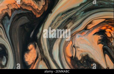 Fluid art with acrylic paint and ink in orange tones, black and gray and blue tones. colorful marble texture floor Stock Photo
