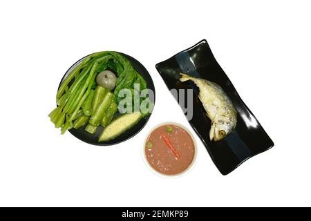 deep fried mackerel fish and spicy shrimp paste sauce eat with mixed boiled vegetable on plate Stock Photo