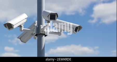 Four CCTV security cameras on a pole Stock Photo