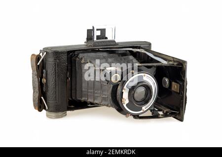 ancient folding camera on white background Stock Photo