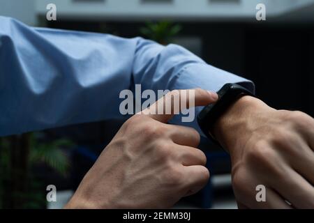 close up of a man interacting with a smart touch watch. watch that connects to your smart phone. life style. no recognizable people. Stock Photo