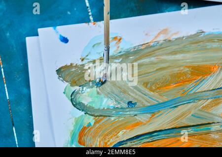 Hand drawn oil painting on blue background with paintbrush Stock Photo