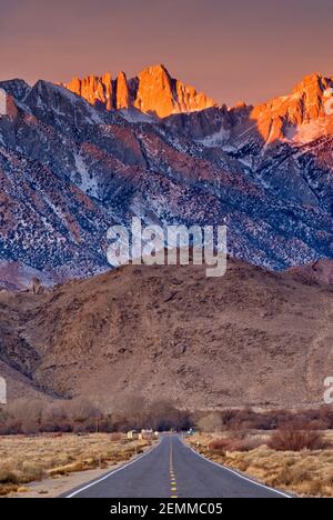 Mount Whitney in Eastern Sierra Nevada, Alabama Hills in foreground seen at sunrise in winter from State Highway 136 near Lone Pine, California, USA Stock Photo