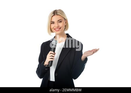 happy anchorwoman with microphone pointing with hand isolated on white Stock Photo