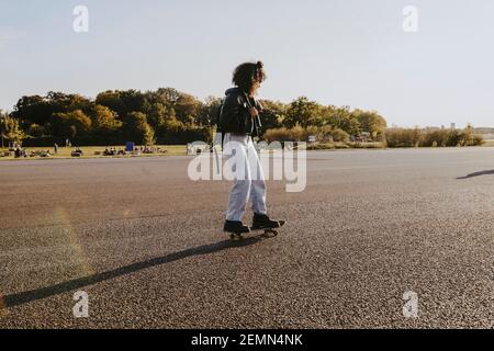 Premium Photo  Adult woman enjoy skating on longboard on empty city street  happy cheerful woman holding skateboard