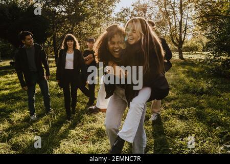 Cheerful friends having fun in park Stock Photo
