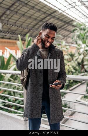Afro businessman In The City Talking On Phone Stock Photo