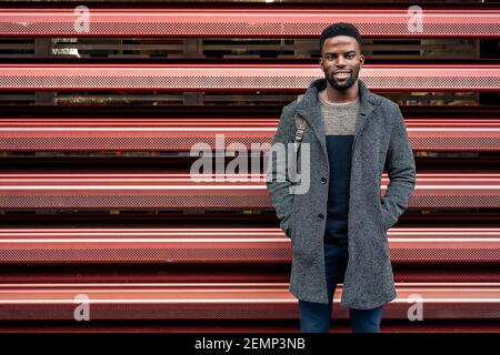 Portrait Of An Afro businessman In The City on a red background Stock Photo